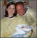 Adoptive couple Debbie and Mark pose with their newborn at the hospital