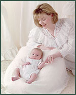 Mom in white and adopted baby on white bean bag