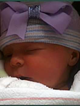 Sleeping baby with purple bow