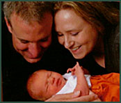 Brandon and Jen admire their newborn adopted baby boy