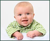 Happy baby boy wearing a green checkered shirt