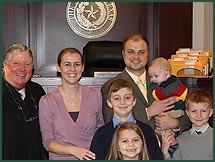 Happy adoptive parents Steph and Chris with their children at adoption finalization