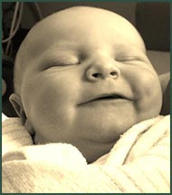 Close up sepia tone of adopted baby smiling