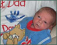 Newborn baby boy wearing a big bib