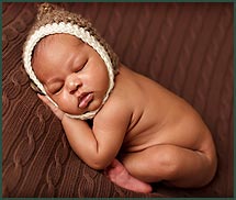 photo of sleeping baby with a hat on