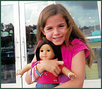 Adopted girl with American Girl doll