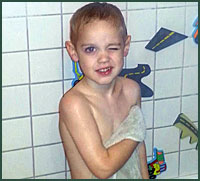 Boy in bath with wall stickers