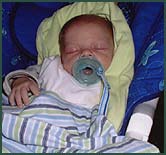 Sleeping newborn baby girl with a pacifier