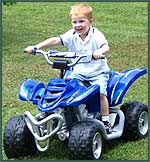 Little boy driving a kid-size four wheeler