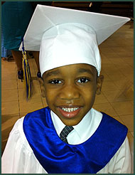 Adopted boy in graduation hat and robe