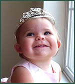 Happy baby girl wearing a tiara
