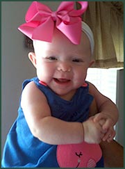 Caucasian baby girl wearing a large pink hair bow