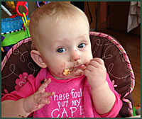 baby eating with messy face