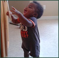 African American toddler boy giggling