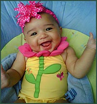 Happy baby girl in flower swimsuit