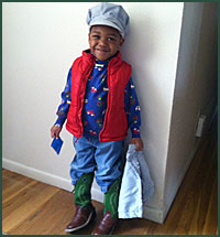 Smiling little boy in a hat and vest
