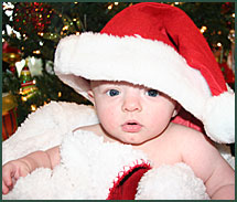 Caucasian baby boy wearing a Santa hat