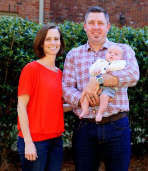 Beaming adoptive parents and their baby boy