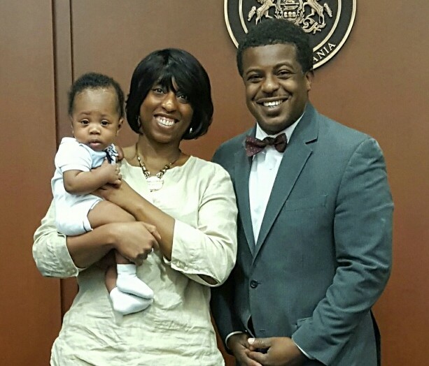 Happy adoptive mother Natacha with her infant son and the judge at the adoption finalization