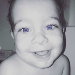 Black and white picture of baby with blue eyes in color