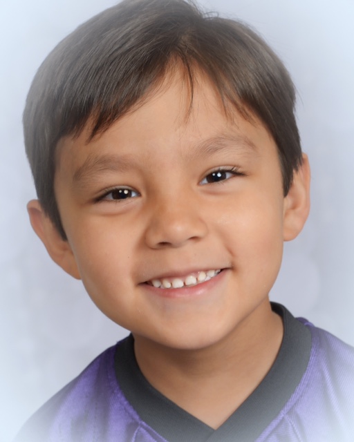 Boy posing for school photo with purple shirt on