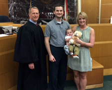 Kevin and Jessica with baby at court