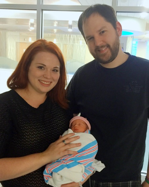 Matt and Julia with newborn baby wrapped in hospital blanket