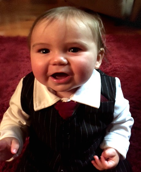 Baby boy dressed up in a vest and tie