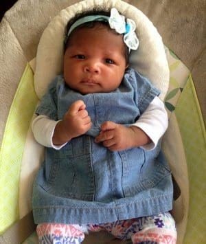 Lovely adopted baby girl with jean dress and bow