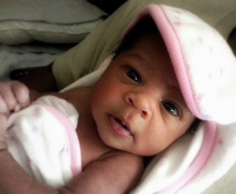 African American newborn baby girl in a bath towel