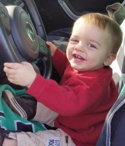 toddler pretends to drive the car