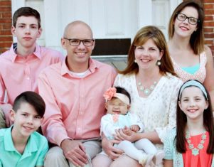 adoptive family posed with newborn