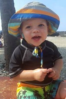 Happy toddler boy at the beach