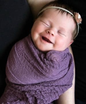 sleeping baby appears to be smiling