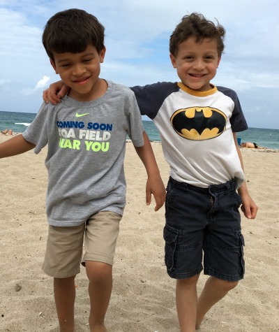 two boys enjoy the beach together