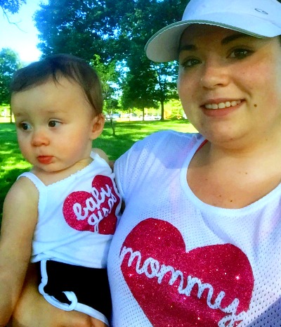 Adoptive mom holding her infant daughter before a 5K