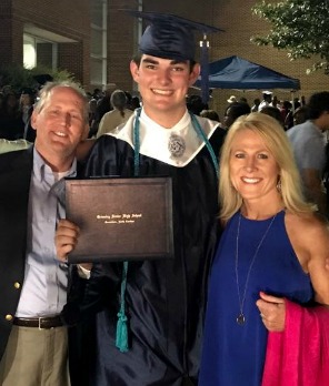 Lifetime adoptive parents Greg and Charmaine at their son's high school graduation