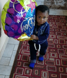Adopted boy with birthday balloon