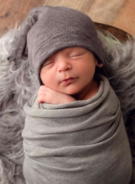 sleeping baby wrapped up with hat