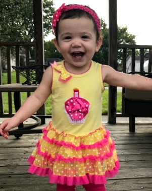 toddler girl in pink and yellow dress