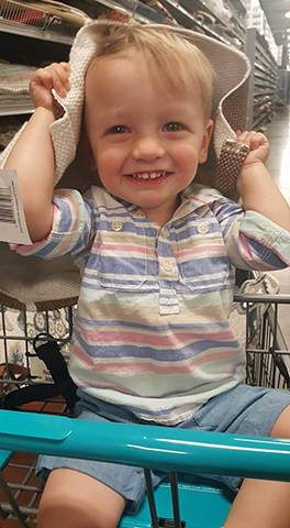 Grayson shows off his new hat in the store