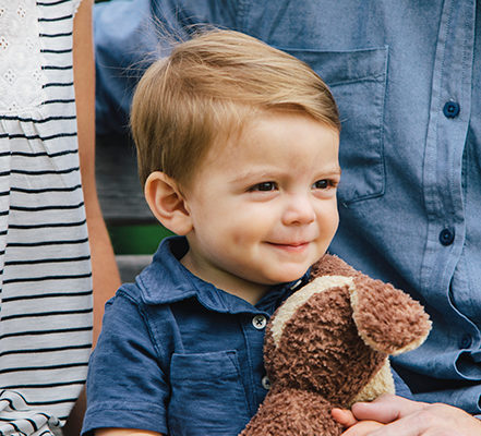 Smiling little boy with his dog stuffed animal