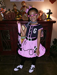 young girl shows off her Halloween costume
