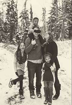 Black and white photo of family in snow
