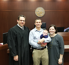 Peter and Helen in court at their son's adoption finalization with the judge