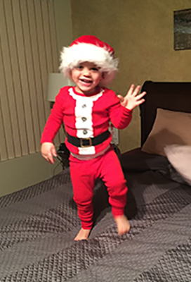 Happy little boy in Santa pajamas