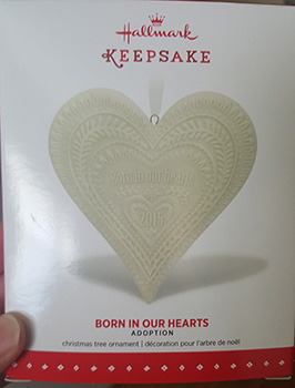 Born in our hearts ornament in package