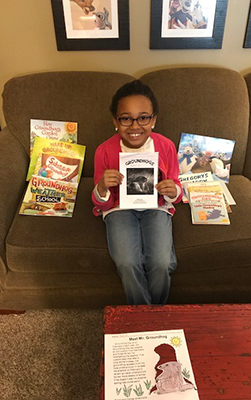 Adoptee Katie poses by her Groundhog Day books