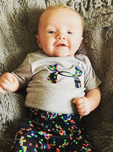 Baby with bright colored pants and Under Armor shirt