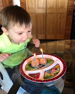 Little boy blowing out his birthday candles